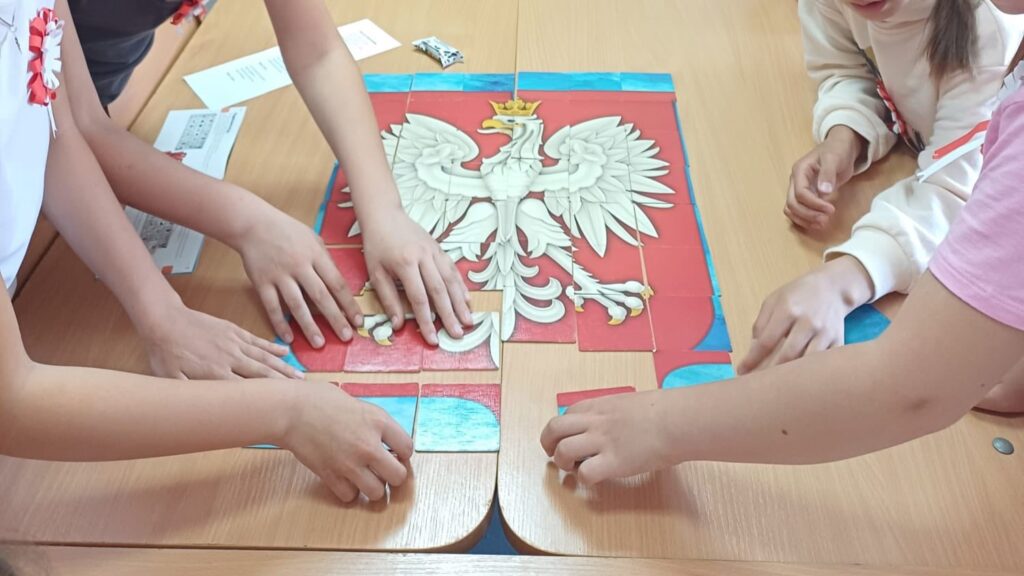Układanie z puzzli polskiego godła przez uczniów